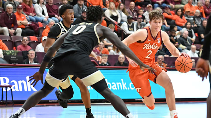 Feb 21, 2026; Blacksburg, Virginia, USA;  Virginia Tech Hokies guard Jaden Schutt (2) drives with the ball defended by Wake Forest Demon Deacons forward Omaha Biliew (0) during the second half at Cassell Coliseum. Mandatory Credit: Brian Bishop-Imagn Images