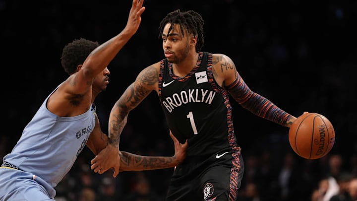 Nov 30, 2018; Brooklyn, NY, USA; Brooklyn Nets point guard D'Angelo Russell (1) controls the ball against Memphis Grizzlies shooting guard MarShon Brooks (8) during the third quarter at Barclays Center. Mandatory Credit: Brad Penner-Imagn Images