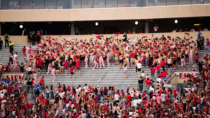 Wisconsin Badger fans take off their shirts and wave them in the second half at Camp Randall Stadium on Saturday, Oct. 18, 2025 in Madison, Wisconsin.