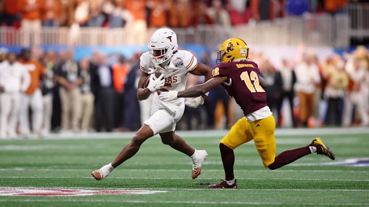 Jan 1, 2025; Atlanta, GA, USA; Texas Longhorns wide receiver Ryan Wingo (5) runs with the ball against Arizona State Sun Devils defensive back Javan Robinson (12) during the second half of the Peach Bowl at Mercedes-Benz Stadium. Mandatory Credit: Brett Davis-Imagn Images
