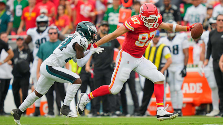 Sep 14, 2025; Kansas City, Missouri, USA; Kansas City Chiefs tight end Travis Kelce (87) carries the ball defended by Philadelphia Eagles safety Andrew Mukuba (24) during the second quarter of the game at GEHA Field at Arrowhead Stadium. Mandatory Credit: Jay Biggerstaff-Imagn Images Sep 14, 2025; Kansas City, Missouri, USA; Kansas City Chiefs tight end Travis Kelce (87) carries the ball defended by Philadelphia Eagles safety Andrew Mukuba (24) during the second quarter of the game at GEHA Field at Arrowhead Stadium. Mandatory Credit: Jay Biggerstaff-Imagn Images