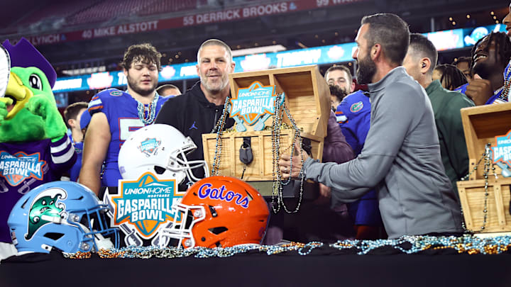 Dec 20, 2024; Tampa, FL, USA; Florida Gators head coach Billy Napier is presented the Gasparilla Bowl championship trophy after the win against the Tulane Green Wave at Raymond James Stadium. Mandatory Credit: Kim Klement Neitzel-Imagn Images