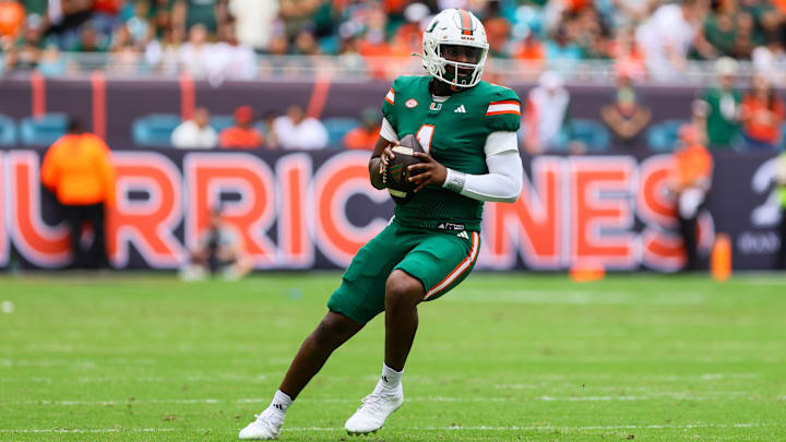 Nov 2, 2024; Miami Gardens, Florida, USA; Miami Hurricanes quarterback Cam Ward (1) looks for a passing option against the Duke Blue Devils during the first quarter at Hard Rock Stadium. Mandatory Credit: Sam Navarro-Imagn Images