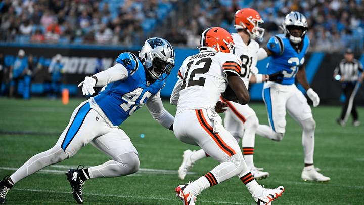 Aug 8, 2025; Charlotte, North Carolina, USA; Cleveland Browns quarterback Shedeur Sanders (12) is tackled by Carolina Panthers linebacker Jon Rhattigan (49) in the second quarter at Bank of America Stadium. Mandatory Credit: Bob Donnan-Imagn Images Aug 8, 2025; Charlotte, North Carolina, USA; Cleveland Browns quarterback Shedeur Sanders (12) is tackled by Carolina Panthers linebacker Jon Rhattigan (49) in the second quarter at Bank of America Stadium. Mandatory Credit: Bob Donnan-Imagn Images