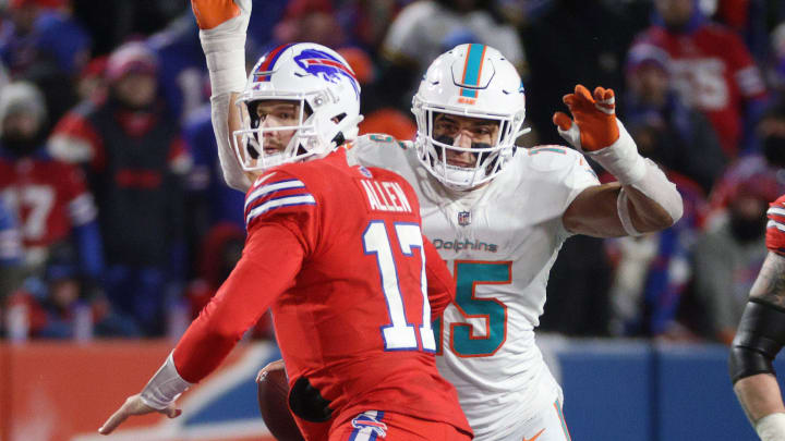 Bills quarterback Josh Allen is about to fumble the ball as he is hit from behind by Miami's Jaelan Phillips.