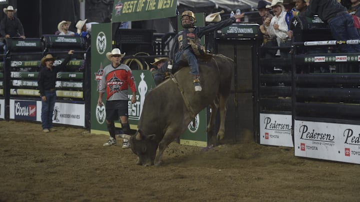 A rider attempts to stay on the bull during night one of PBR's Last Cowboy Standing showcase event on July 21, 2025 at CSU's Canvas Stadium in Fort Collins, Colo.
