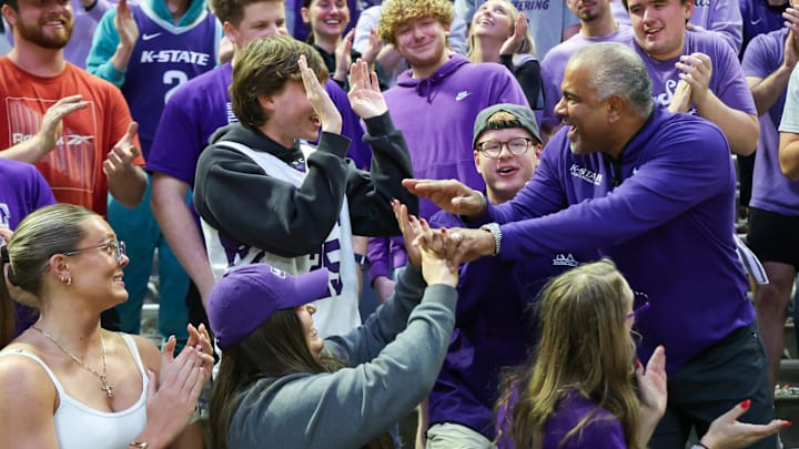 Nov 17, 2025; Manhattan, Kansas, USA; Kansas State Wildcats head coach Jerome Tang celebrates with students in the stands following a win against the Tulsa Golden Hurricane at Bramlage Coliseum. 