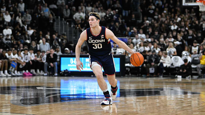 Mar 1, 2025; Providence, Rhode Island, USA; Connecticut Huskies forward Liam McNeeley (30) dribbles against the Providence Friars  during the second half at Amica Mutual Pavilion. Mandatory Credit: Eric Canha-Imagn Images