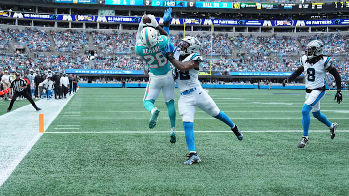 Miami Dolphins running back De'Von Achane (28) catches a touchdown pass as Carolina Panthers linebacker Trevin Wallace (32) defends in the second quarter at Bank of America Stadium. Miami Dolphins running back De'Von Achane (28) catches a touchdown pass as Carolina Panthers linebacker Trevin Wallace (32) defends in the second quarter at Bank of America Stadium.