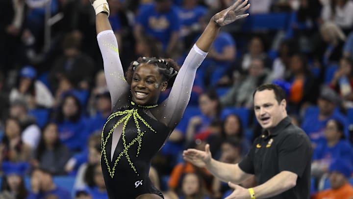 Mar 30, 2023; Los Angeles, CA, USA;  Amari Celestine of Missouri completes her floor exercise routine as coach Shannon Welker applauds during the NCAA Women's Gymnastics Los Angeles Regional at Pauley Pavilion. Mandatory Credit: Robert Hanashiro-Imagn Images