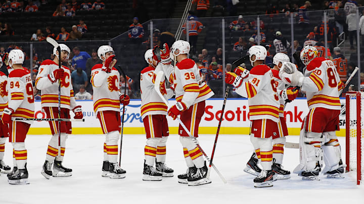 Oct 13, 2024; Edmonton, Alberta, CAN; The Calgary Flames celebrate a 4-1 win over the Edmonton Oilers at Rogers Place. Mandatory Credit: Perry Nelson-Imagn Images