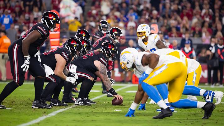 Oct 21, 2024; Glendale, Arizona, USA; General view down the line of scrimmage as Arizona Cardinals center Hjalte Froholdt (72) prepares to snap the ball against the Los Angeles Chargers at State Farm Stadium. Mandatory Credit: Mark J. Rebilas-Imagn Images