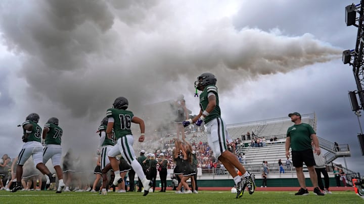 Edmond Santa Fe runs on to the field before the high school football game between Edmond Santa Fe and Jenks at Edmond Santa Fe High School in Edmond, Okla., Friday, Aug. 29, 2025. Edmond Santa Fe runs on to the field before the high school football game between Edmond Santa Fe and Jenks at Edmond Santa Fe High School in Edmond, Okla., Friday, Aug. 29, 2025.
