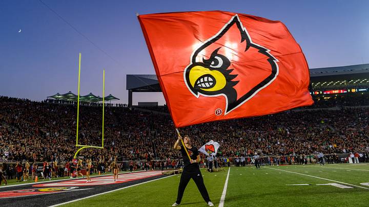 Sep 2, 2019; Louisville, KY, USA; A Louisville Cardinals cheerleader waves a flag following a Louisville touchdown in the first quarter against the Notre Dame Fighting Irish at Cardinal Stadium. Mandatory Credit: Matt Cashore-USA TODAY Sports Sep 2, 2019; Louisville, KY, USA; A Louisville Cardinals cheerleader waves a flag following a Louisville touchdown in the first quarter against the Notre Dame Fighting Irish at Cardinal Stadium. Mandatory Credit: Matt Cashore-USA TODAY Sports