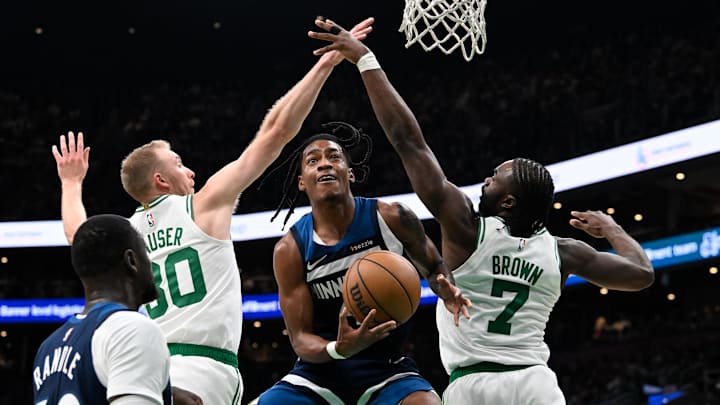 Nov 24, 2024; Boston, Massachusetts, USA; Boston Celtics forward Sam Hauser (30) and guard Jaylen Brown (7) defend against Minnesota Timberwolves guard Rob Dillingham (4) during the second half at TD Garden. Mandatory Credit: Eric Canha-Imagn Images