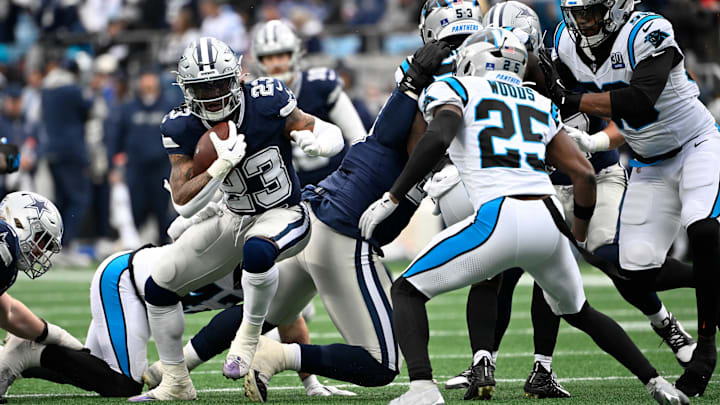 Dallas Cowboys running back Rico Dowdle with the ball past Carolina Panthers safety Xavier Woods.