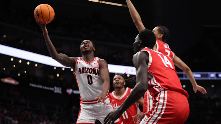 Mar 14, 2026; Kansas City, MO, USA; Arizona Wildcats guard Jaden Bradley (0) drives to the hoop past Houston Cougars forward Kalifa Sakho (14) and guard Milos Uzan (7) during the first half during the men's Big 12 Conference Tournament Championship at T-Mobile Center. Mandatory Credit: William Purnell-Imagn Images Mar 14, 2026; Kansas City, MO, USA; Arizona Wildcats guard Jaden Bradley (0) drives to the hoop past Houston Cougars forward Kalifa Sakho (14) and guard Milos Uzan (7) during the first half during the men's Big 12 Conference Tournament Championship at T-Mobile Center. Mandatory Credit: William Purnell-Imagn Images