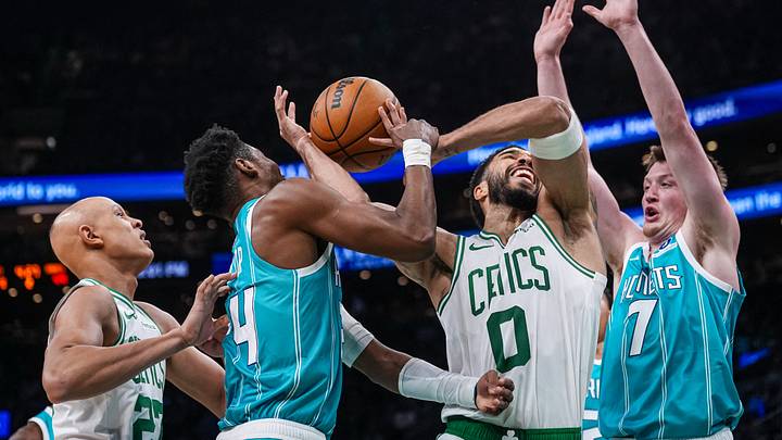 Boston Celtics forward Jayson Tatum (0) drives the ball against Charlotte Hornets forward Brandon Miller (24) and guard Kon Knueppel Boston Celtics forward Jayson Tatum (0) drives the ball against Charlotte Hornets forward Brandon Miller (24) and guard Kon Knueppel