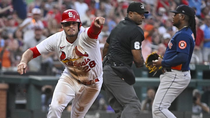 Jun 27, 2023; St. Louis, Missouri, USA; St. Louis Cardinals third baseman Nolan Arenado (28) points to his dugout to challenge the out call at home after sliding past the tag of Houston Astros starting pitcher Framber Valdez (59) during the fifth inning at Busch Stadium. Arenado was called out on the play but the call was overturned after a successful challenge by the Cardinals. Mandatory Credit: Jeff Curry-Imagn Images Jun 27, 2023; St. Louis, Missouri, USA; St. Louis Cardinals third baseman Nolan Arenado (28) points to his dugout to challenge the out call at home after sliding past the tag of Houston Astros starting pitcher Framber Valdez (59) during the fifth inning at Busch Stadium. Arenado was called out on the play but the call was overturned after a successful challenge by the Cardinals. Mandatory Credit: Jeff Curry-Imagn Images