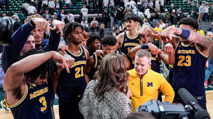 Michigan players pose around head coach Dusty May during a postgame interview with Fox to celebrate the 83-71 win over Michigan State at Breslin Center in East Lansing on Friday, Jan. 30, 2026. Michigan players pose around head coach Dusty May during a postgame interview with Fox to celebrate the 83-71 win over Michigan State at Breslin Center in East Lansing on Friday, Jan. 30, 2026.