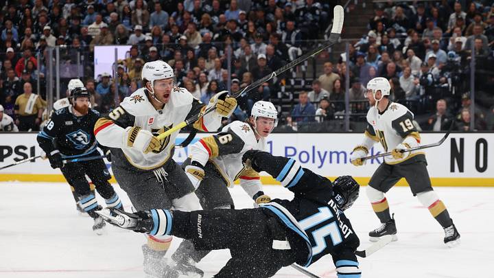 Apr 24, 2026; Salt Lake City, Utah, USA; Utah Mammoth center Alexander Kerfoot (15) is tripped up by Vegas Golden Knights defenseman Jeremy Lauzon (5) during the first period in game three of the first round of the 2026 Stanley Cup Playoffs at Delta Center. Mandatory Credit: Rob Gray-Imagn Images