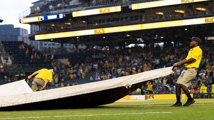 Jul 1, 2023; Pittsburgh, Pennsylvania, USA; The Pittsburgh Pirates grounds crew pulls the tarp onto the field  during a rain delay in the ninth inning against the Milwaukee Brewers at PNC Park. Mandatory Credit: Scott Galvin-USA TODAY Sports