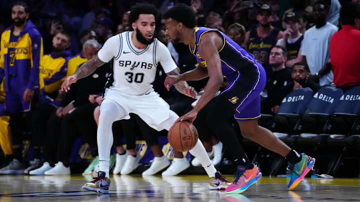 Mar 17, 2025; Los Angeles, California, USA: Los Angeles Lakers guard Bronny James (9) dribbles the ball against San Antonio Spurs forward Julian Champagnie (30) at the Crypto.com Arena. Mandatory Credit: Kirby Lee-Imagn Images