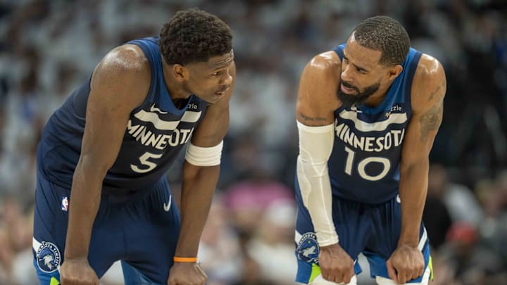 May 14, 2025; Minneapolis, Minnesota, USA; Minnesota Timberwolves guard Anthony Edwards (5) looks on with Minnesota Timberwolves guard Mike Conley (10) against the Golden State Warriors in the first half during game five of the second round for the 2025 NBA Playoffs at Target Center. Mandatory Credit: Jesse Johnson-Imagn Images