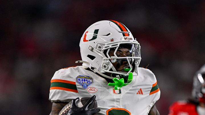 Dec 31, 2025; Arlington, TX, USA; Miami Hurricanes defensive back Keionte Scott (0) returns an interception for a touchdown during the 2025 Cotton Bowl and quarterfinal game of the College Football Playoff at AT&T Stadium. Mandatory Credit: Jerome Miron-Imagn Images