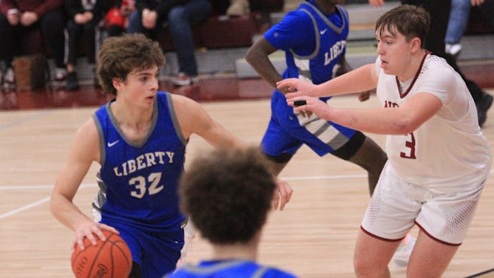 Olentangy Liberty's Tyler Kropp drives from the top of the key against Newark's Steele Meister during the visiting Patriots' 58-49 victory at Jimmy Allen Gymnasium on Tuesday, Dec. 19, 2023.