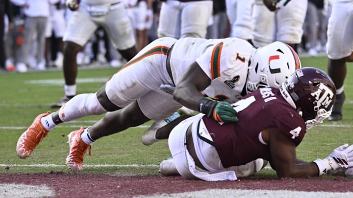 Dec 20, 2025; College Station, TX, USA; Miami Hurricanes linebacker Mohamed Toure (1) hits Texas A&M Aggies running back Rueben Owens II (4) at the goal line during the second half of the first round game of the CFP National Playoff at Kyle Field. Mandatory Credit: Jerome Miron-Imagn Images