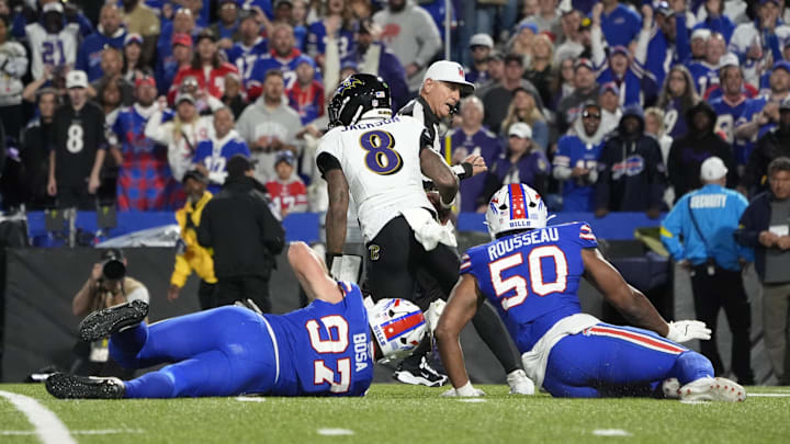 Sep 7, 2025; Orchard Park, New York, USA;  Baltimore Ravens quarterback Lamar Jackson (8) runs the ball during the fourth quarter against Buffalo Bills defensive end Greg Rousseau (50) and defensive end Joey Bosa (97)