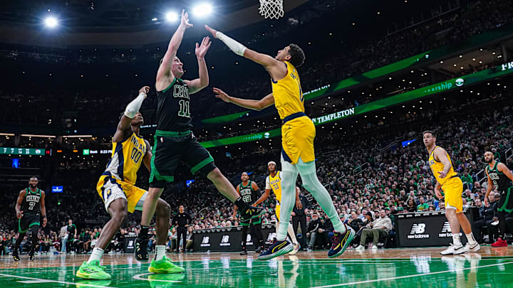 Dec 27, 2024; Boston, Massachusetts, USA; Boston Celtics guard Payton Pritchard (11) shoots the ball against Indiana Pacers guard Tyrese Haliburton (0) in the second quarter at TD Garden. Mandatory Credit: David Butler II-Imagn Images