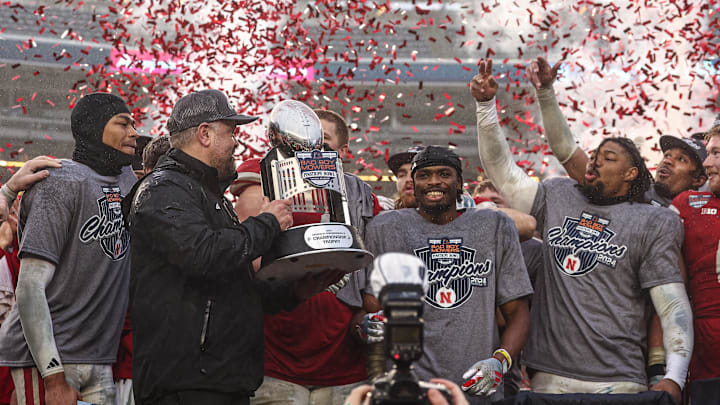 Dec 28, 2024; Bronx, NY, USA; Nebraska Cornhuskers head coach Matt Rhule holds the championship trophy as Cornhuskers players celebrate after the game against the Boston College Eagles at Yankee Stadium. 