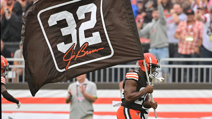 Sep 10, 2023; Cleveland, Ohio, USA; Cleveland Browns running back Nick Chubb (24) runs on the field with a flag honoring former Browns player Jim Brown before the game between the Browns and the Cincinnati Bengals at Cleveland Browns Stadium. Mandatory Credit: Ken Blaze-Imagn Images