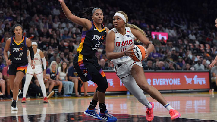 May 25, 2025; Phoenix, Arizona, USA; Washington Mystics forward Kiki Iriafen (44) drives on Phoenix Mercury forward Alyssa Thomas (25) in the first half at Footprint Center. Mandatory Credit: Rick Scuteri-Imagn Images