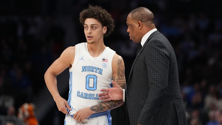 Mar 12, 2026; Charlotte, NC, USA; North Carolina Tar Heels head coach Hubert Davis with guard Kyan Evans (0) in the first half at Spectrum Center. Mandatory Credit: Bob Donnan-Imagn Images