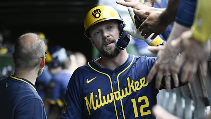 Jun 19, 2025; Chicago, Illinois, USA; Milwaukee Brewers first baseman Rhys Hoskins (12) celebrates in the dugout after he homers against the Chicago Cubs during the second inning at Wrigley Field. Mandatory Credit: Matt Marton-Imagn Images Jun 19, 2025; Chicago, Illinois, USA; Milwaukee Brewers first baseman Rhys Hoskins (12) celebrates in the dugout after he homers against the Chicago Cubs during the second inning at Wrigley Field. Mandatory Credit: Matt Marton-Imagn Images