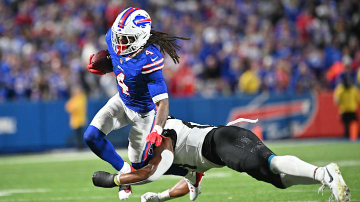 Buffalo Bills running back James Cook (4) is tackled by Jacksonville Jaguars linebacker Ventrell Miller (51) in the third quarter at Highmark Stadium. Buffalo Bills running back James Cook (4) is tackled by Jacksonville Jaguars linebacker Ventrell Miller (51) in the third quarter at Highmark Stadium.