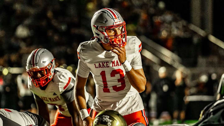 Lake Mary quarterback Noah Grubbs (13), shown here in an earlier game against Bishop Moore, completed 23 of 34 passes for 309 yards and two touchdowns and ran for another score to power the Rams to a 31-26 upset of defending Class 7A state champ Venice in a state semifinal game on Friday, Dec. 5, 2025.  The victory catapulted Lake Mary to No. 1 in this week's High School on SI Central Florida Top 10 Football rankings.