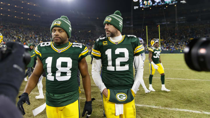 Jan 8, 2023; Green Bay, Wisconsin, USA;  Green Bay Packers quarterback Aaron Rodgers (12) and wide receiver Randall Cobb (18) walk off the field following the game against the Detroit Lions at Lambeau Field. Mandatory Credit: Jeff Hanisch-USA TODAY Sports