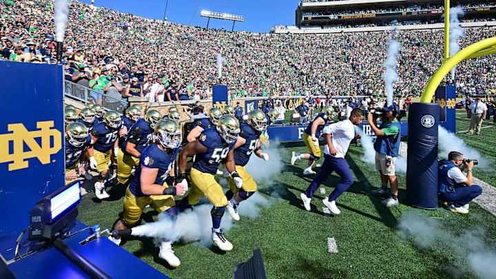 Sep 21, 2024; South Bend, Indiana, USA; Notre Dame Fighting Irish head coach Marcus Freeman leads his team onto the field for the game against the Miami Redhawks at Notre Dame Stadium. Mandatory Credit: Matt Cashore-Imagn Images Sep 21, 2024; South Bend, Indiana, USA; Notre Dame Fighting Irish head coach Marcus Freeman leads his team onto the field for the game against the Miami Redhawks at Notre Dame Stadium. Mandatory Credit: Matt Cashore-Imagn Images