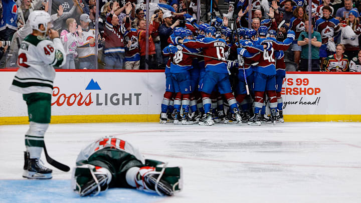 May 13, 2026; Denver, Colorado, USA; Colorado Avalanche players celebrate after the game as Minnesota Wild goaltender Jesper Wallstedt (30) lies on the ice next to defenseman Jared Spurgeon (46) in game five of the second round of the 2026 Stanely Cup Playoffs at Ball Arena. Mandatory Credit: Isaiah J. Downing-Imagn Images