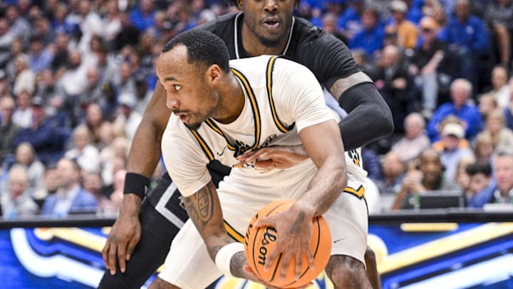 Mar 13, 2025; Nashville, TN, USA; Mississippi State Bulldogs forward Cameron Matthews (4) defends as Missouri Tigers guard Tamar Bates (2) controls the ball during the second half at Bridgestone Arena. Mandatory Credit: Steve Roberts-Imagn Images Mar 13, 2025; Nashville, TN, USA; Mississippi State Bulldogs forward Cameron Matthews (4) defends as Missouri Tigers guard Tamar Bates (2) controls the ball during the second half at Bridgestone Arena. Mandatory Credit: Steve Roberts-Imagn Images