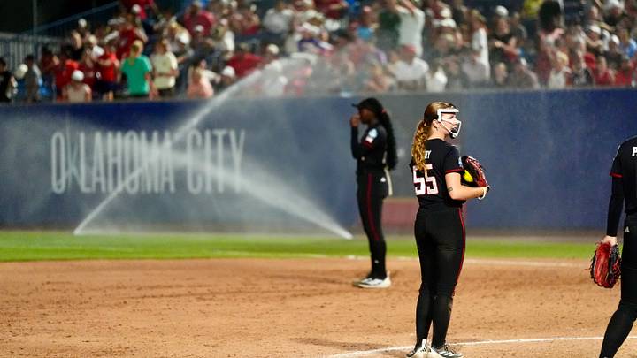 Sprinklers go off, interrupting the Women's College World Series softball game between Texas Tech Red Raiders and the UCLA Bruins at Devon Park in Oklahoma City, May 31, 2026. Sprinklers go off, interrupting the Women's College World Series softball game between Texas Tech Red Raiders and the UCLA Bruins at Devon Park in Oklahoma City, May 31, 2026.