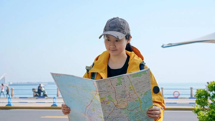 Young traveler reading paper map Young traveler reading paper map