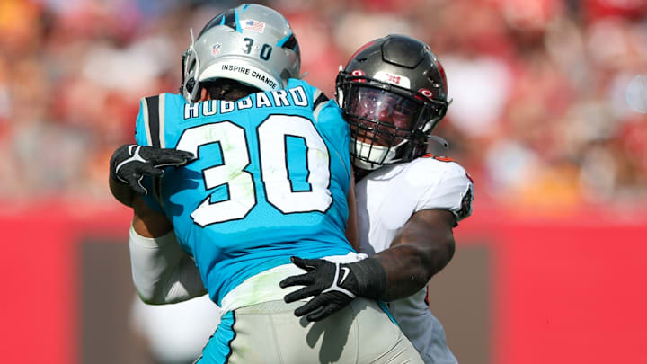 Jan 1, 2023; Tampa, Florida, USA; Tampa Bay Buccaneers linebacker Lavonte David (54) tackles Carolina Panthers running back Chuba Hubbard (30) in the second quarter at Raymond James Stadium.