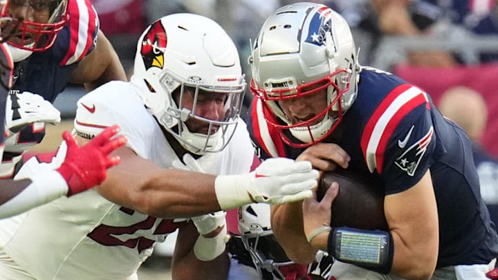 Arizona Cardinals linebacker Zaven Collins (25) drags down New England Patriots quarterback Drake Maye (10) at State Farm Stadium on Dec. 15, 2024.