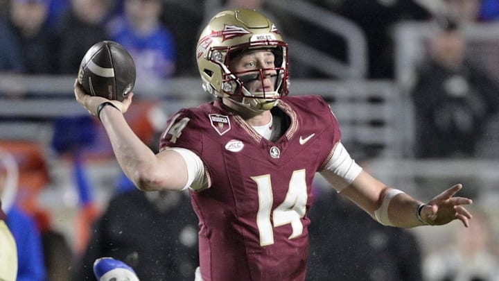 Florida State Seminoles quarterback Luke Kromenhoek (14) looks to throw as he is tackled by Florida Gators defensive back Bryce Thornton (18) during the second half at Doak S. Campbell Stadium.