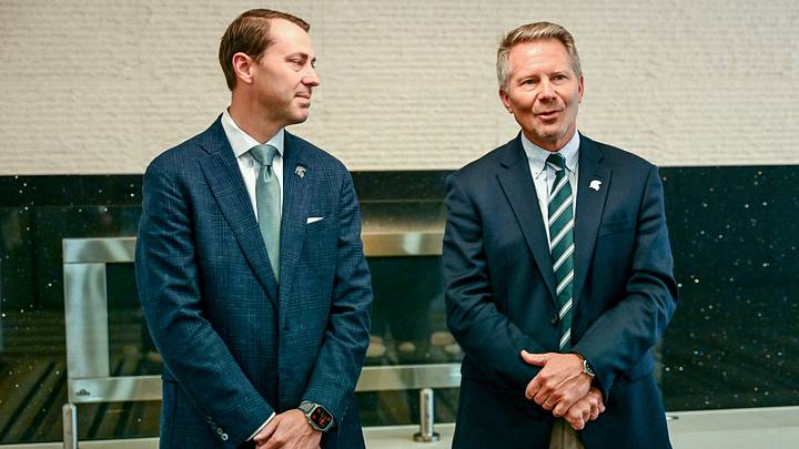Michigan State University President Kevin Guskiewicz, right, as MSU Athletic Director J Batt looks on before the two’s panel discussion hosted by the Lansing Economic Club on Thursday, Sept. 11, 2025, at the Kellogg Center in East Lansing. Michigan State University President Kevin Guskiewicz, right, as MSU Athletic Director J Batt looks on before the two’s panel discussion hosted by the Lansing Economic Club on Thursday, Sept. 11, 2025, at the Kellogg Center in East Lansing.